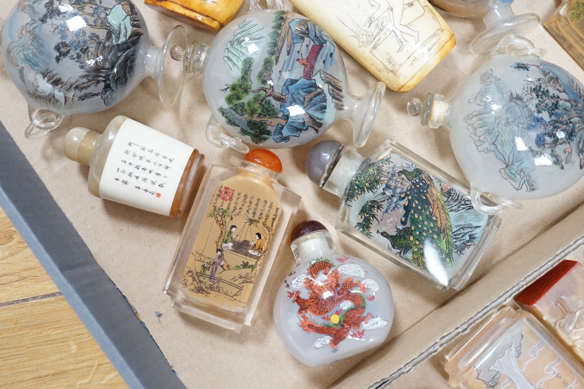 A collection of Chinese snuff bottles, mostly reverse painted (2 trays)